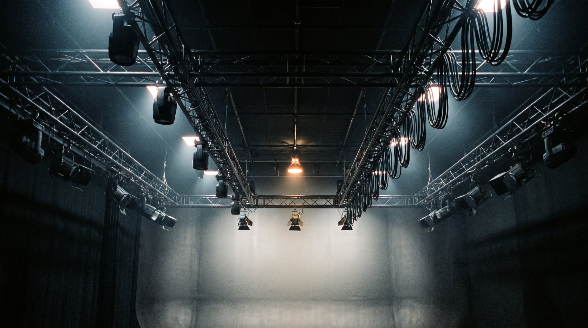 Studio lighting truss seen from below, beams raking onto a cyclorama, SKY Network Television