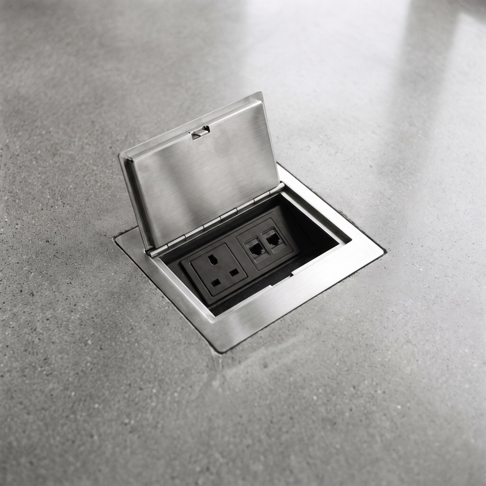 Flush floor box set into polished concrete, lid open