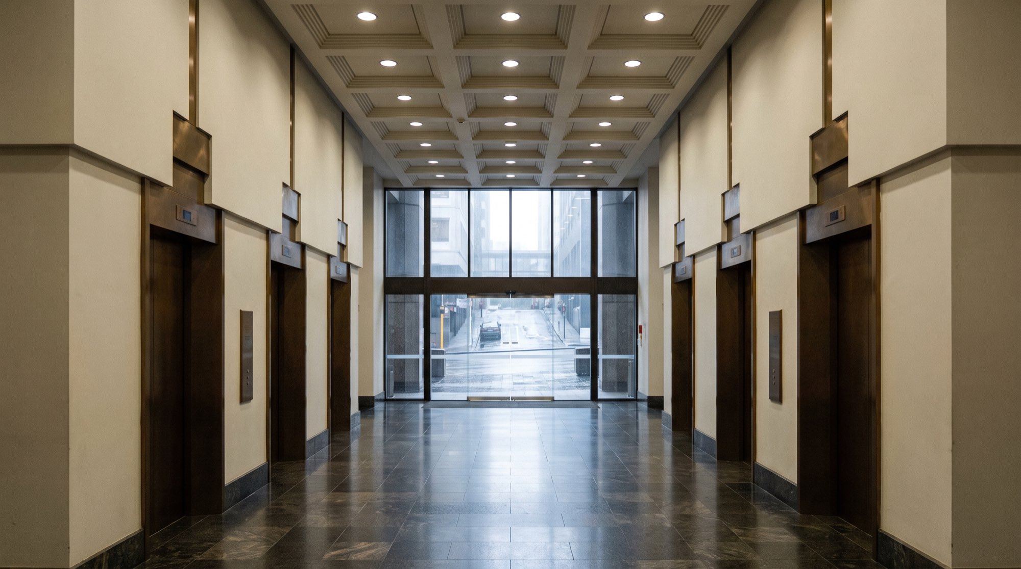 Tower lobby with a coordinated grid of recessed downlights, 55 Shortland Street